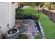 Stone patio area alongside the house, featuring a garden and utility access at 10005 Lakeview Pkwy, Villa Rica, GA 30180