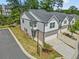 Aerial view of townhomes featuring attached garages and well-manicured lawns in a beautiful community at 1385 Vayda Ct, Marietta, GA 30066