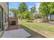 The backyard offers a large, grassy area perfect for outdoor activities, with some tree coverage for shade at 1385 Vayda Ct, Marietta, GA 30066
