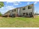 View of the well-maintained backyard, featuring a lawn, small patio, and privacy fences at 1385 Vayda Ct, Marietta, GA 30066