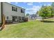 View of the backyard and neighboring homes with a well-maintained lawn at 1385 Vayda Ct, Marietta, GA 30066