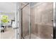 Modern bathroom features a glass-enclosed tiled shower and an open view into the bedroom at 1385 Vayda Ct, Marietta, GA 30066