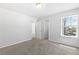 Carpeted bedroom featuring natural light from a window and double-door closets at 1385 Vayda Ct, Marietta, GA 30066