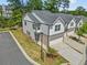 Aerial view of a neighborhood showcasing townhomes with well-kept lawns and driveway parking at 1385 Vayda Ct, Marietta, GA 30066