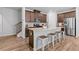 Modern kitchen featuring stainless steel appliances, a large island with seating, and stylish wood cabinets at 1385 Vayda Ct, Marietta, GA 30066