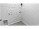 Small laundry area with gray tile floor, hookups, and wire shelving at 1385 Vayda Ct, Marietta, GA 30066