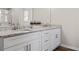 Bathroom with double vanity, granite counters, white cabinets and stainless steel hardware at 2851 Fareed St, Douglasville, GA 30135