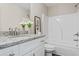 Bathroom featuring a granite-top vanity, framed mirror, and a shower-tub combo at 2851 Fareed St, Douglasville, GA 30135