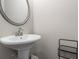 Half bath with pedestal sink, modern mirror and towel rack at 2851 Fareed St, Douglasville, GA 30135