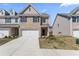 Charming two-story brick townhome featuring an attached garage and manicured front lawn at 2851 Fareed St, Douglasville, GA 30135