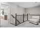 Upstairs landing area featuring chair, wood railing, and access to bedrooms at 2851 Fareed St, Douglasville, GA 30135