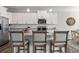 Kitchen boasts stainless steel appliances, granite countertops, and a breakfast bar with upholstered stools at 2851 Fareed St, Douglasville, GA 30135