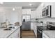Updated kitchen featuring stainless appliances, granite countertops, and white cabinetry at 2851 Fareed St, Douglasville, GA 30135