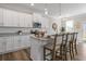 Bright kitchen featuring white cabinets, granite counters, a breakfast bar and stainless steel appliances at 2851 Fareed St, Douglasville, GA 30135