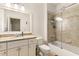 Bright bathroom with a tiled shower-tub, granite vanity, and neutral color scheme at 3290 Camellia Ln, Suwanee, GA 30024