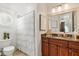 Charming bathroom with granite countertop vanity and a tub/shower combination with decorative curtain at 3290 Camellia Ln, Suwanee, GA 30024