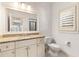 Bright bathroom featuring granite countertop, a framed mirror, and single sink at 3290 Camellia Ln, Suwanee, GA 30024
