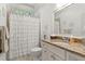 Cozy bathroom featuring a granite vanity, single sink, and shower with curtain at 3290 Camellia Ln, Suwanee, GA 30024