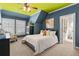 Cozy bedroom features a queen-size bed, colorful decor, carpet, and an ensuite bathroom with bright natural light at 3290 Camellia Ln, Suwanee, GA 30024