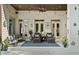 Inviting covered patio with stylish lounge furniture and overhead string lights at 3290 Camellia Ln, Suwanee, GA 30024