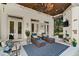 Inviting covered patio with stylish lounge furniture, fireplace and overhead string lights at 3290 Camellia Ln, Suwanee, GA 30024