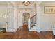 Inviting foyer with hardwood floors, white wainscoting, staircase and a view into other rooms at 3290 Camellia Ln, Suwanee, GA 30024