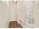 Bright entryway with bench seating, modern tile floor, and convenient wall storage at 3290 Camellia Ln, Suwanee, GA 30024
