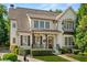 Charming two-story home with well-maintained landscaping, covered front porch, and stylish details at 3290 Camellia Ln, Suwanee, GA 30024