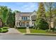 Charming two-story home with manicured lawn, stone walkway, and inviting front porch at 3290 Camellia Ln, Suwanee, GA 30024