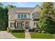 Charming two-story home featuring a stone walkway, lush landscaping, and a welcoming front porch at 3290 Camellia Ln, Suwanee, GA 30024