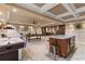 Spacious game room features an air hockey table, billiard table, marble island, and sleek flooring at 3290 Camellia Ln, Suwanee, GA 30024