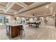 Recreation room featuring an island, billiards table, dart board, coffered ceilings, and ample natural light at 3290 Camellia Ln, Suwanee, GA 30024