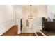 Upstairs hallway with hardwood floors, modern lighting, and a view of the staircase at 3290 Camellia Ln, Suwanee, GA 30024