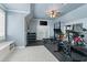 Spacious home gym featuring a variety of exercise equipment and a ceiling fan and doors for natural light at 3290 Camellia Ln, Suwanee, GA 30024