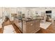 Open concept kitchen with a view to living area creates a seamless flow for entertaining at 3290 Camellia Ln, Suwanee, GA 30024