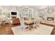 Open concept living and dining room featuring hardwood floors, coffered ceiling, and built-in shelving at 3290 Camellia Ln, Suwanee, GA 30024