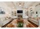 Bright living room featuring coffered ceilings, stone fireplace, and custom built-in shelving at 3290 Camellia Ln, Suwanee, GA 30024