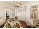 Comfortable sitting area with a view of a home office, featuring a decorative art piece and accent lighting at 3290 Camellia Ln, Suwanee, GA 30024