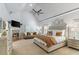 Large main bedroom with fireplace, seating area, vaulted ceilings, and serene natural light at 3290 Camellia Ln, Suwanee, GA 30024