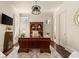 Well-lit home office with a large desk, custom cabinetry, and ample storage space and shuttered window at 3290 Camellia Ln, Suwanee, GA 30024