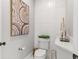 Modern powder room features a white vessel sink with sleek faucet, unique tilework, and an elegant artistic design at 3290 Camellia Ln, Suwanee, GA 30024