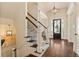 Elegant staircase with decorative carpet runner and dark wood steps, leading to the upper level at 3290 Camellia Ln, Suwanee, GA 30024