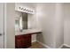 Bathroom with sink, vanity, and large mirror featuring vanity lights above at 11151 Aliyah Dr, Hampton, GA 30228