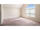 Bright bedroom featuring a high ceiling and a large arched window at 11151 Aliyah Dr, Hampton, GA 30228