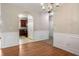 Open-concept dining area with hardwood floors, showcasing seamless transition to the kitchen at 11151 Aliyah Dr, Hampton, GA 30228
