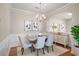 Elegant dining room with wainscoting, modern lighting, and neutral decor, perfect for Gathering gatherings at 11151 Aliyah Dr, Hampton, GA 30228