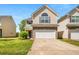 Traditional two-story home featuring a two-car garage and manicured lawn at 11151 Aliyah Dr, Hampton, GA 30228