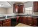 Well-equipped kitchen with dark wood cabinetry and essential appliances at 11151 Aliyah Dr, Hampton, GA 30228