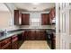Functional kitchen featuring dark cabinetry, black appliances and tile flooring at 11151 Aliyah Dr, Hampton, GA 30228