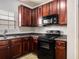 Functional kitchen featuring dark wood cabinets, efficient appliances, and ample counter space for cooking at 11151 Aliyah Dr, Hampton, GA 30228